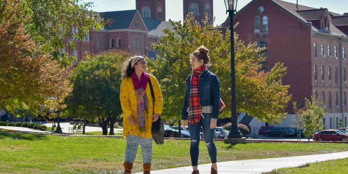 Two students walk together on campus