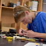 A BCYC Immersion student assembles an engineering project in class